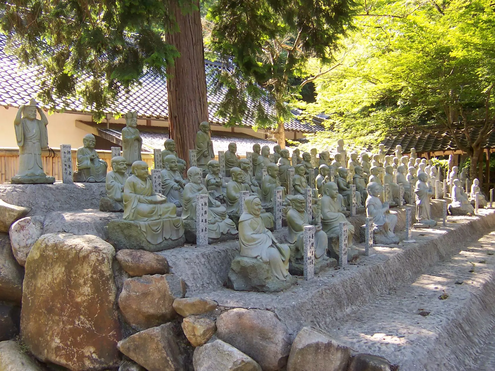 Small stone statues of past abbots in the garden at Butsuji Temple, Japan.